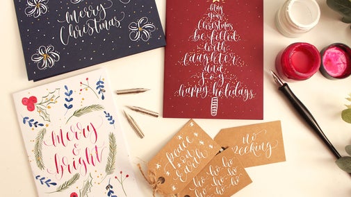 Christmas cards decorated with small watercolour paintings and calligraphy